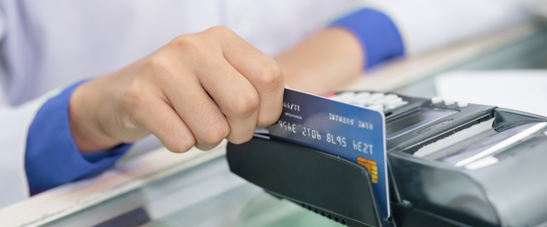 Woman swiping a credit card