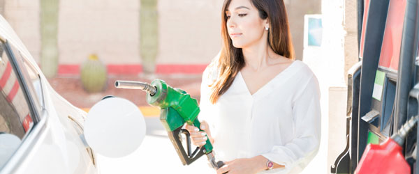 Woman about to pump gas