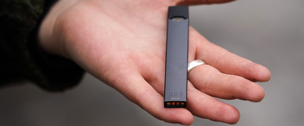 Person holding a JUUL Product