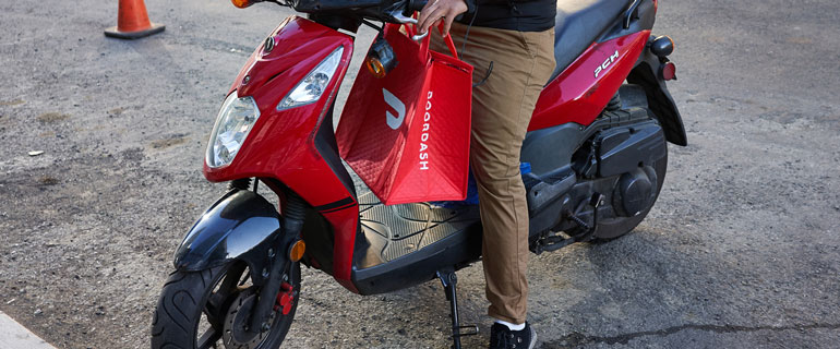DoorDash Delivery Driver With A Food Delivery Bag